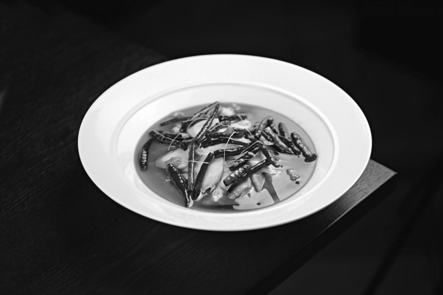 Hands preparing fresh vegetables for plant-based cooking class