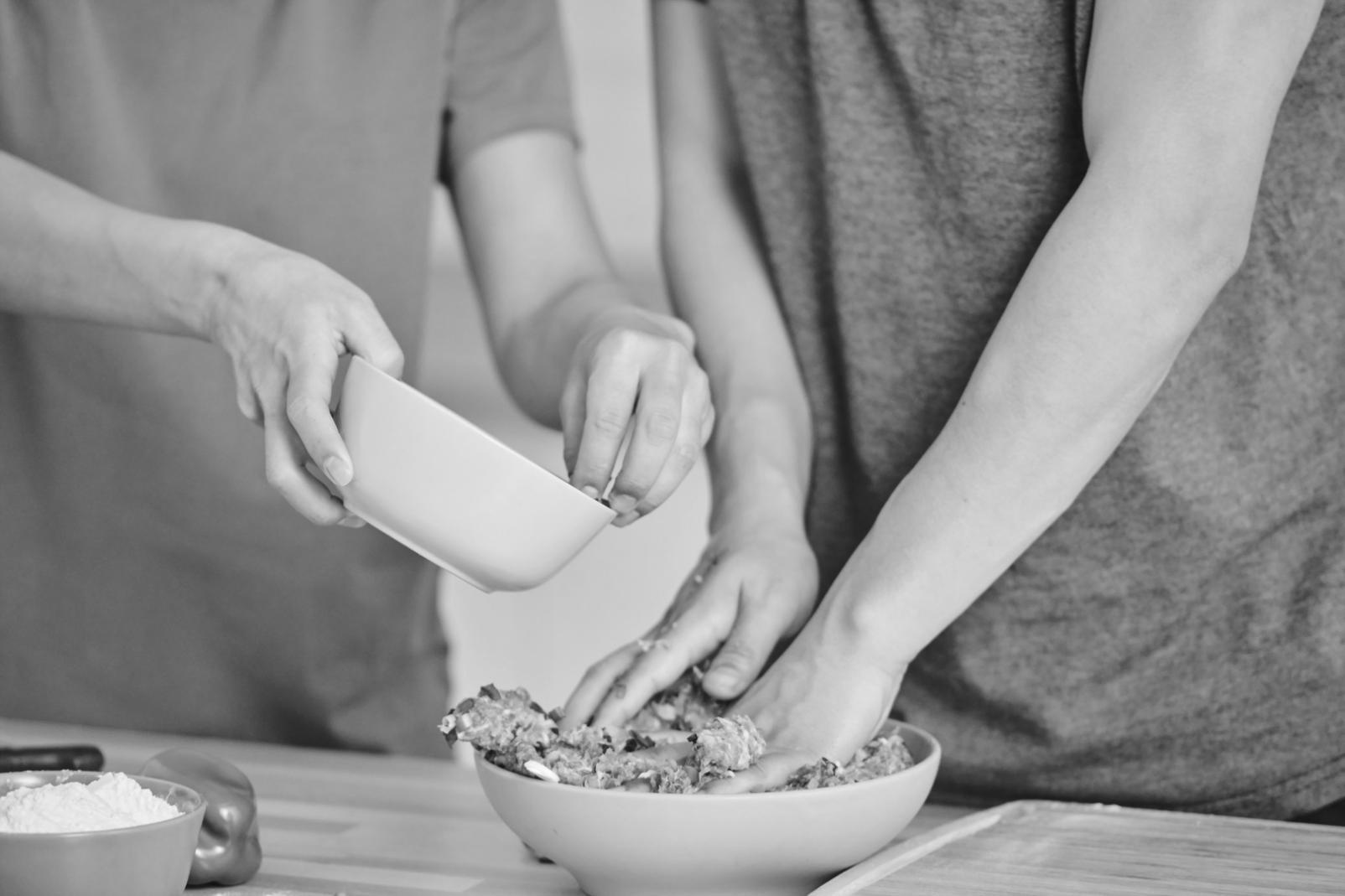 Student practicing knife skills with fresh produce during cooking class