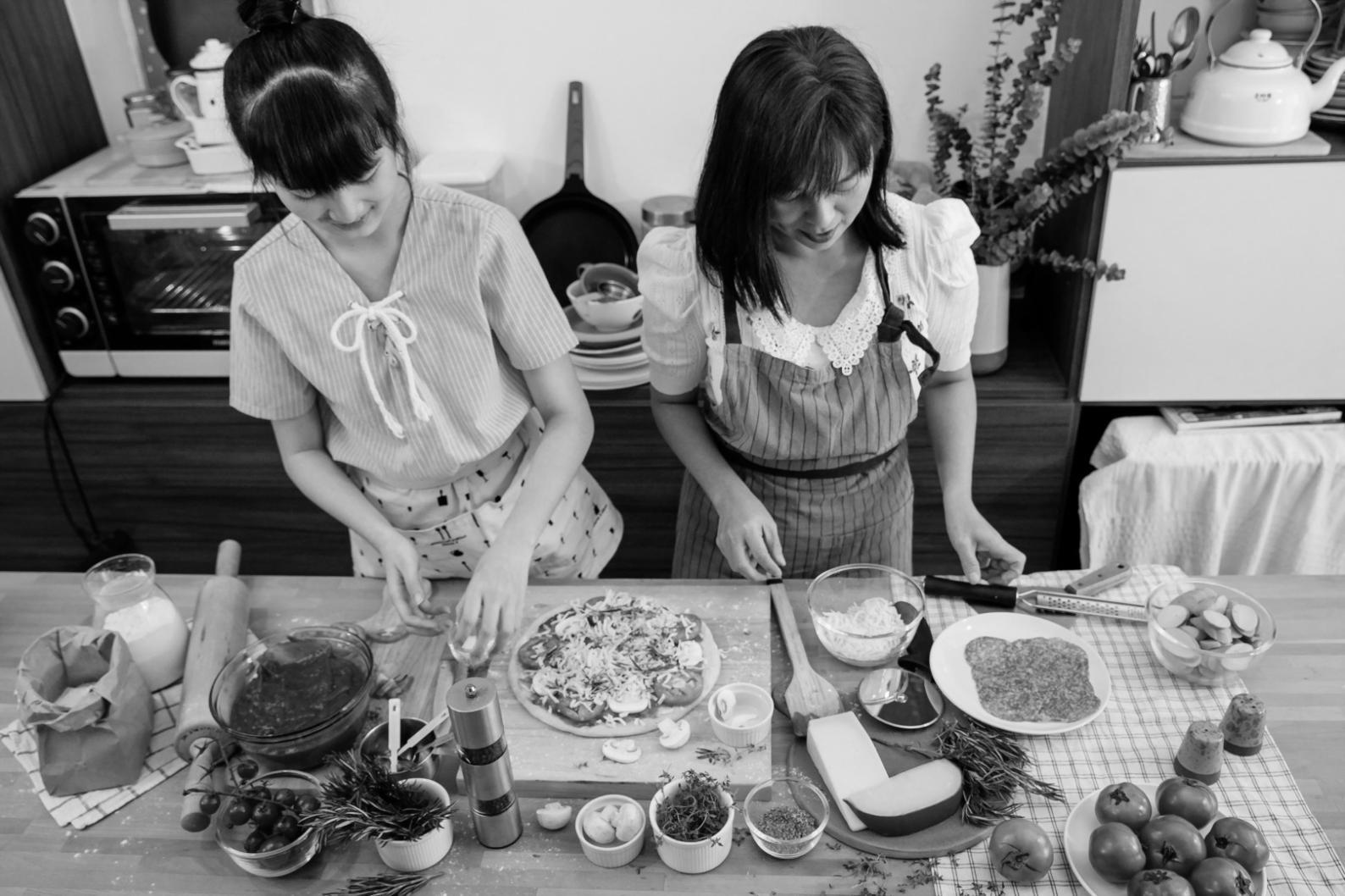 Students collaborating on plant-based cooking techniques in a kitchen setting
